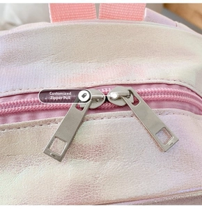 Close-up of laser-reflective PU fabric and dual metal zippers on a mermaid backpack