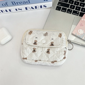 Detail of white quilted mini bag featuring cute bear pattern and side metal ring connector