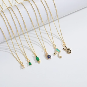 Golden chain necklaces with cubic zirconia pendants in various creative shapes on white