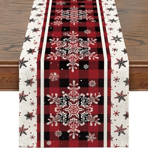 Close-up of red and black buffalo check Christmas table runner with white snowflake patterns