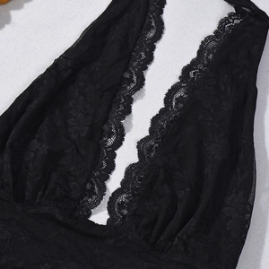 Detail shot of black lace dress with deep V-neckline and intricate scalloped floral edges