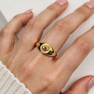 Detailed view of an 18K gold plated evil eye ring featuring a vibrant red zircon stone