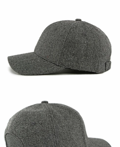 Detail of dark gray wool baseball cap showing thick felt texture and adjustable strap