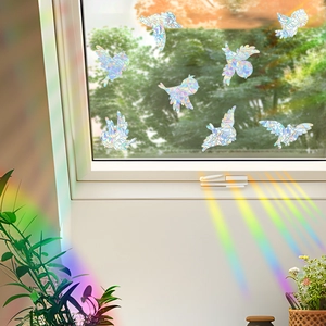 Rainbow effect on wall from bird shaped laser window film with prism light reflection
