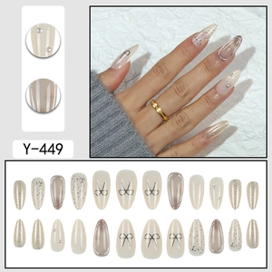 Short almond press-on nails set in beige with 3D silver bows and pearl accents
