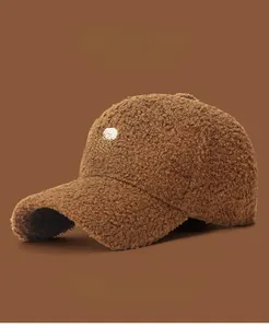 Detail of embroidered white R letter on soft brown lamb wool baseball cap for women