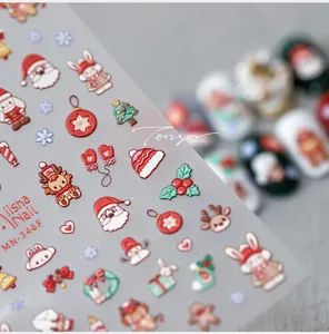 Macro shot of 3D Christmas nail decals featuring Santa, reindeer, and festive snowflakes