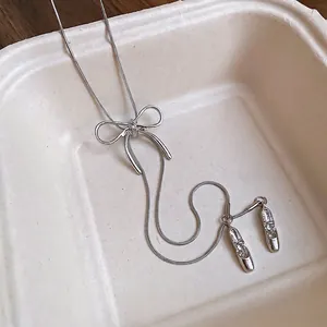 Silver bow and crystal ballet slipper pendant necklace on a sleek snake chain