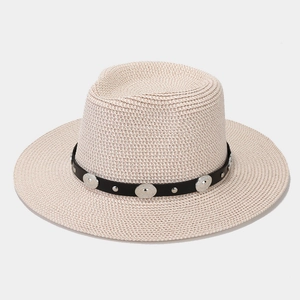 Detail view of woven straw Panama hat with black leatherette band and silver studs