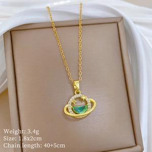 Detailed view of luxury green gemstone planet pendant with micro-paved diamonds on gold chain