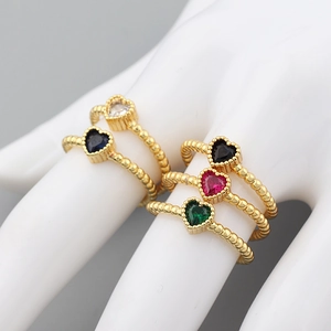 Macro detail of 18k gold plated heart-cut colorful zircon rings with beaded metal bands