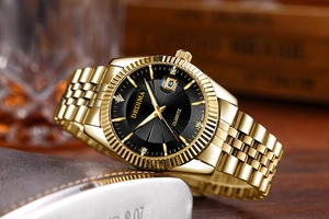 Macro shot of gold quartz watch with black sunray dial and classic fluted bezel details