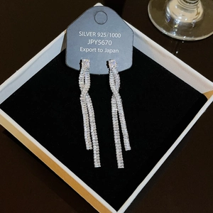 Detail of silver 925 long tassel earrings with white zircon in premium jewelry box