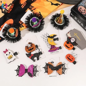 Detail of Halloween hair clips with pumpkin, ghost, and bat sequins on a display card