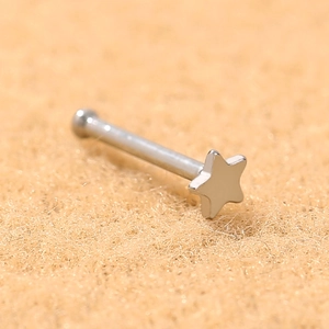 Macro detail of a polished silver stainless steel star nose stud with ball end