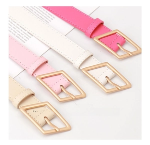 Detail of stylish leather belts in fuchsia, white, pink, and beige with geometric metal buckles