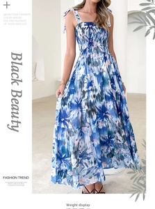 Detail showing the smocked elastic bodice and tie-shoulder straps on floral maxi dress