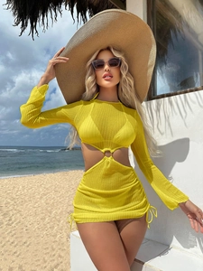Detail of yellow hollow-out knit beach cover-up with metal ring and long sleeves