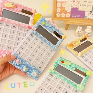 Detail of DIY cream glue calculator with 3D resin rabbits and colorful floral charms