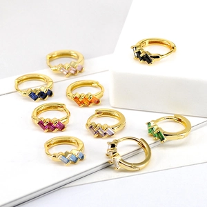 Collection of gold huggie hoop earrings with colorful rectangular step-cut cubic zirconia