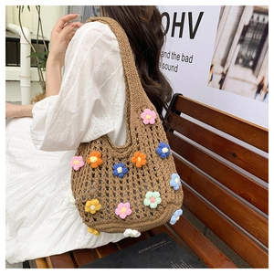Detailed view of handmade crochet floral tote bag with 3D colorful knit flowers