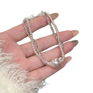 Elegant double-layered pearl necklace with large pearl pendant on a silver-tone chain