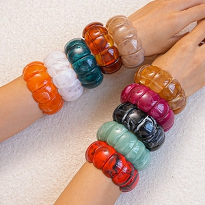 Macro shot of colorful acrylic geometric stretch bracelets with high gloss finish