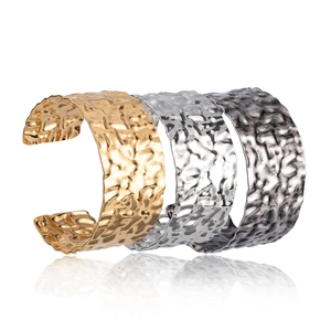 Minimalist wide cuff bracelets with hammered texture in gold, silver, and gun black