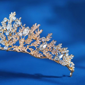 Close-up of luxury bridal crown featuring golden leaves and sparkling crystal branches