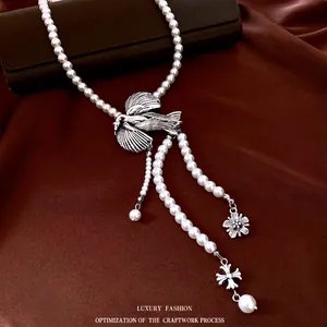 Vintage multi-layer pearl necklace with silver bird pendant and floral charms