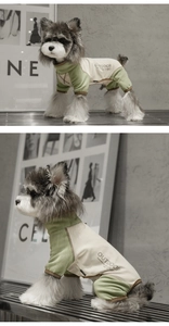 Detail of color-block green pet onesie showing ribbed cuffs and outdoor-themed back print