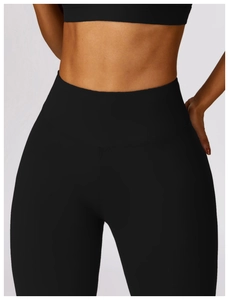 Close-up of high-waisted black yoga leggings with wide tummy control waistband
