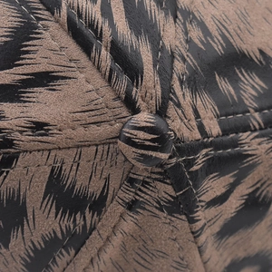 Close-up of the leopard print cap top showing fine stitching and button detail