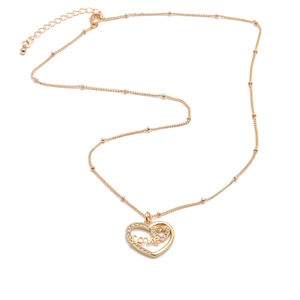 Close-up of gold plated heart necklace with rhinestones and Love inscription detail
