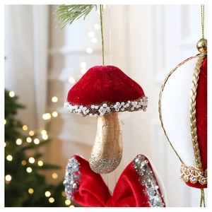 Close-up of red velvet mushroom Christmas ornament with white beads and golden glitter
