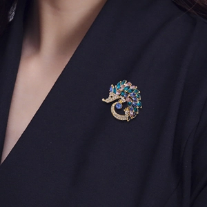 Golden hedgehog brooch with colorful rhinestones pinned on a black suit lapel
