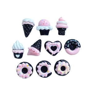 10-piece black and pink resin miniature sweets including ice cream and donuts on white background