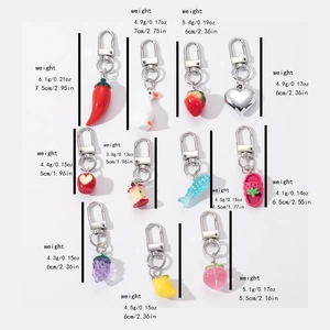 Detailed view of assorted resin fruit and vegetable charms with metal keychains and sizes