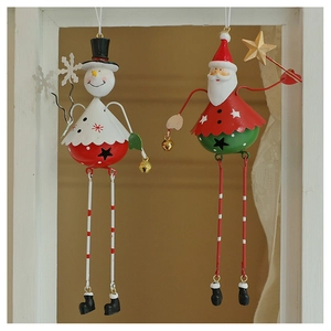 Detail of painted tin Christmas snowman and Santa Claus ornaments with dangling legs