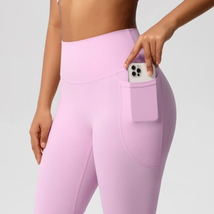 Detail view of high waist yoga pants featuring a functional side pocket for a smartphone