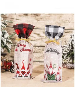 Detail of Christmas wine bags with red black plaid trim and festive gnome prints