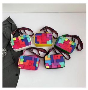 Flat lay of colorful geometric square handbags with wide shoulder straps in five colors