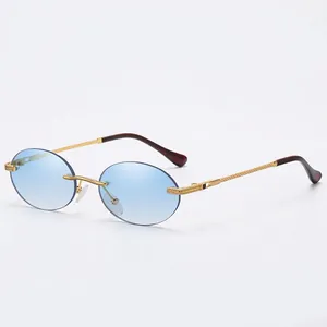 Rimless oval sunglasses with blue gradient lenses and gold engraved metal temples