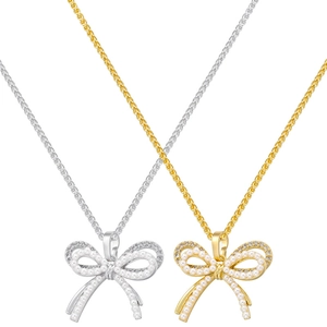 Detailed view of gold and silver bow necklaces with pearl and zircon inlay accents