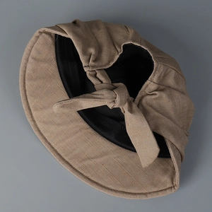 Linen sun hat in khaki with a decorative bow back detail on a grey background