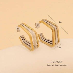 Detail of geometric C-shaped stainless steel earrings with gold and silver two-tone finish
