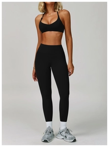Detail view of high-elastic black yoga set featuring a backless bra and high-waist leggings