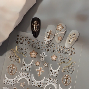 Metallic gold 3D embossed nail stickers featuring leopard print and cross designs