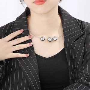 Punk style stainless steel collar necklace with three large silver spheres on a female model