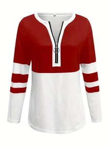 Detail of the V-neck zipper with metal ring pull and red-white contrast stitching